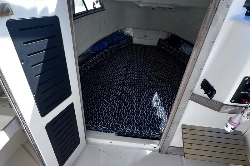 Slide: The Image of 1994 Grady-White 20 Adventure cabin interior with patterned flooring and storage compartments. - 7