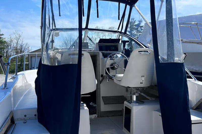 Slide: The Image of 1994 Grady-White 20 Adventure boat interior with steering wheel and seating. - 8