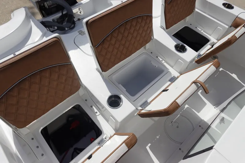 Slide: The Image of 2026 Sea Hunt BX 25 FS boat interior with brown cushioned seats and storage compartments. - 11