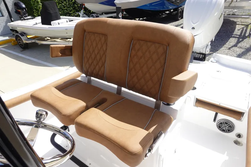 Slide: The Image of 2026 Sea Hunt BX 25 FS boat with tan leather seating and steering wheel. - 15
