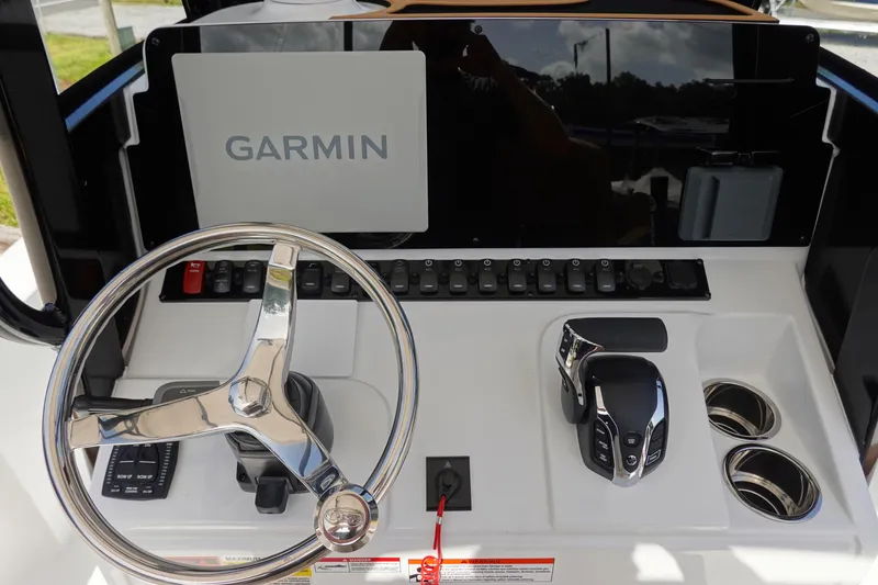 Slide: The Image of 2026 Sea Hunt BX 25 FS boat dashboard with Garmin display and steering wheel. - 17