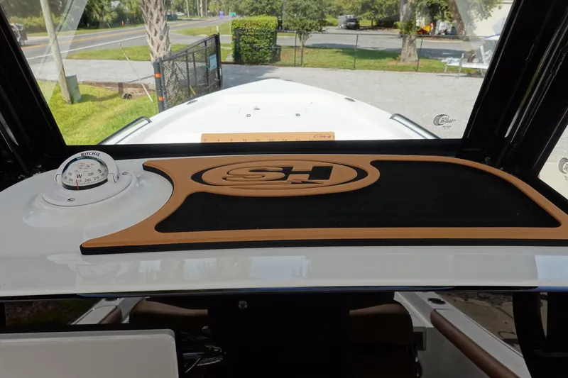 Slide: The Image of 2026 Sea Hunt BX 25 FS boat dashboard with compass and logo mat. - 20