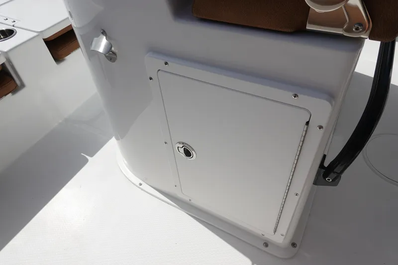 Slide: The Image of 2026 Sea Hunt BX 25 FS boat console storage compartment with latch and cup holders. - 22