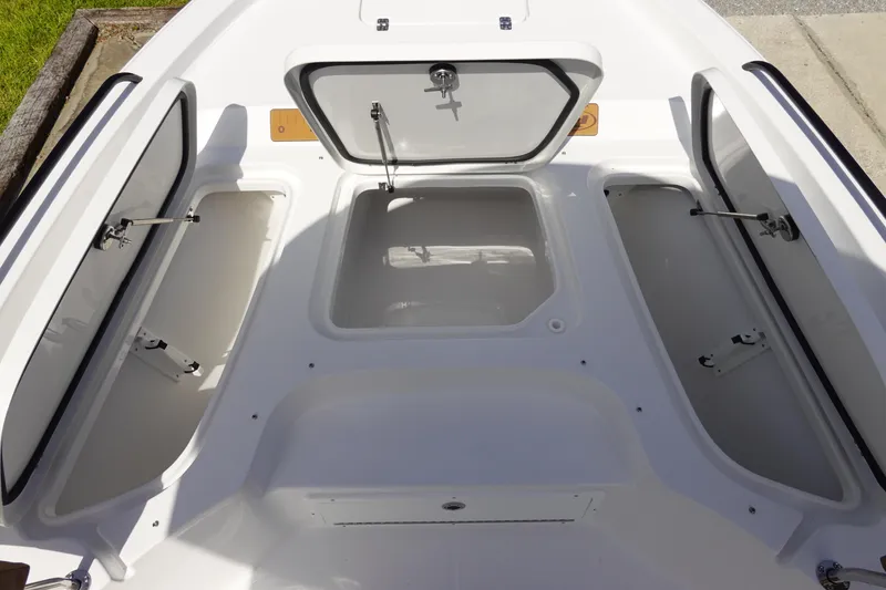 Slide: The Image of Open storage compartments on a 2026 Sea Hunt BX 25 FS boat deck. - 30
