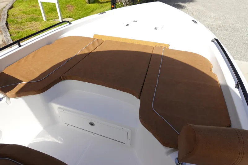 Slide: The Image of 2026 Sea Hunt BX 25 FS boat with brown cushioned seating in the bow area. - 32