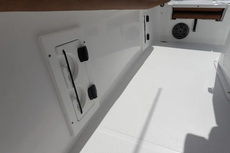 Slide: The Image of Interior view of 2026 Sea Hunt BX 25 FS boat, featuring storage compartments and speaker. - 38