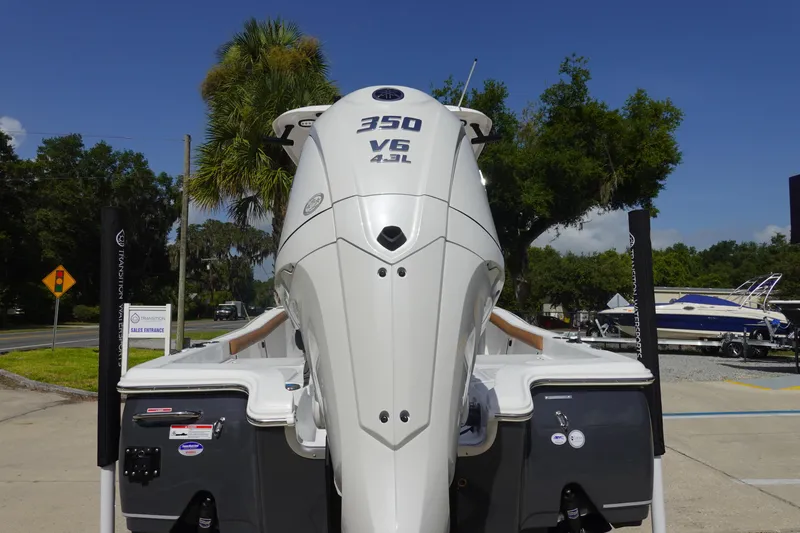Slide: The Image of 2026 Sea Hunt BX 25 FS boat with powerful 350 V6 engine, parked outdoors. - 5
