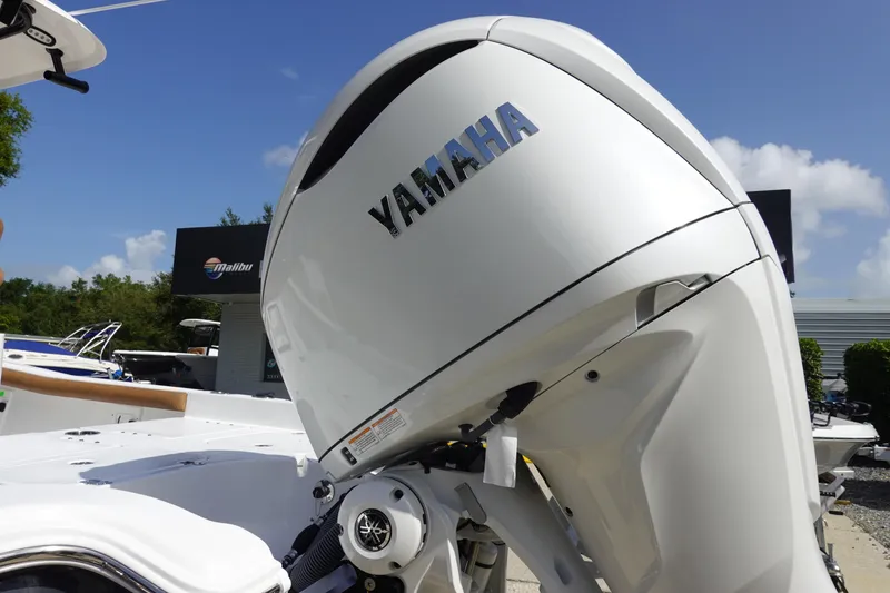 Slide: The Image of 2026 Sea Hunt BX 25 FS with Yamaha outboard motor in a sunny outdoor setting. - 7