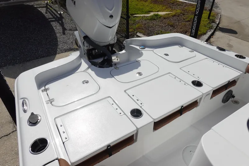Slide: The Image of 2026 Sea Hunt BX 25 FS boat deck with storage compartments and outboard motor. - 8