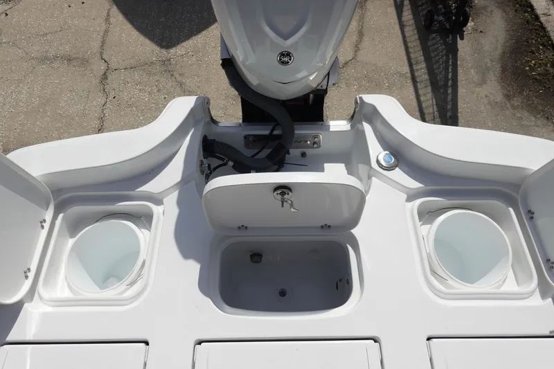 Slide: The Image of 2026 Sea Hunt BX 25 FS boat deck with storage compartments and motor. - 9