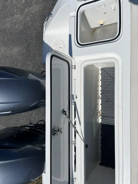 Slide: The Image of 2022 Sea Hunt Gamefish 27 Forward Seating boat with open storage compartments. - 17