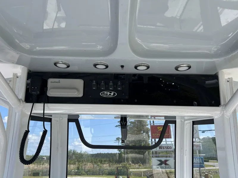 Slide: The Image of 2022 Sea Hunt Gamefish 27 Forward Seating dashboard with controls and Garmin device. - 22