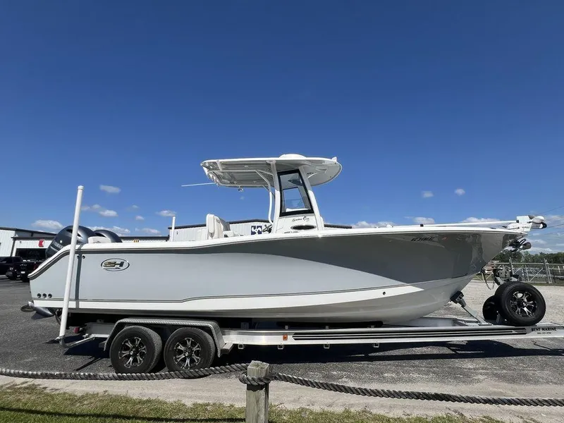 Slide: The Image of 2022 Sea Hunt Gamefish 27 boat on trailer under clear blue sky. - 4