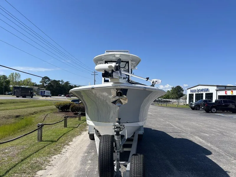 Slide: The Image of 2022 Sea Hunt Gamefish 27 boat on trailer, parked outdoors under clear blue sky. - 6