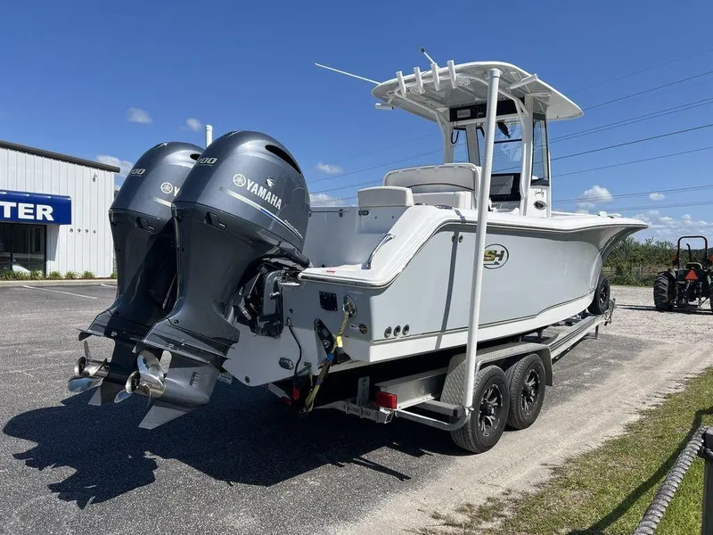 Slide: The Image of 2022 Sea Hunt Gamefish 27 boat with dual Yamaha engines on a trailer. - 7