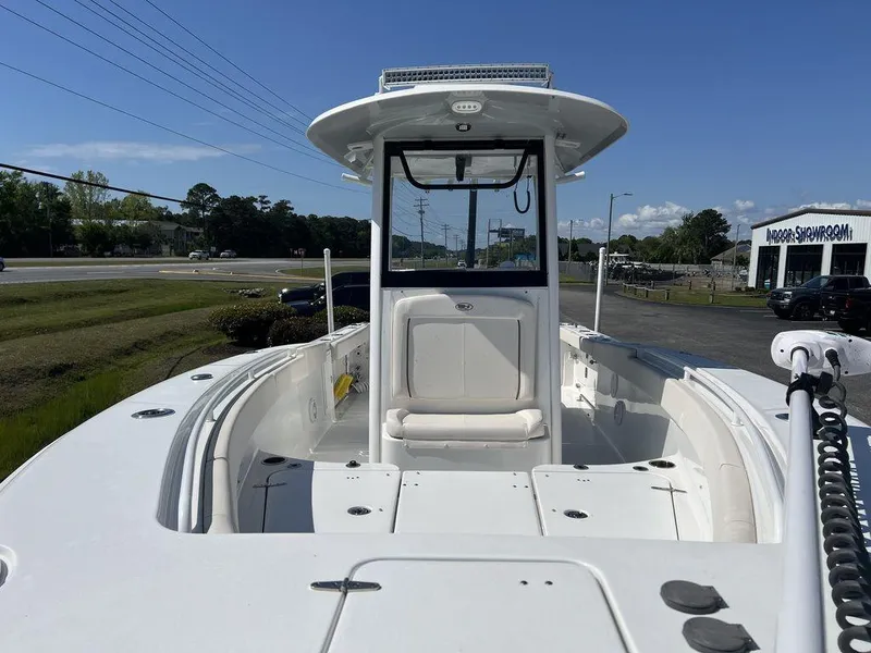 Slide: The Image of 2022 Sea Hunt Gamefish 27 Forward Seating boat, white exterior, parked outdoors. - 9