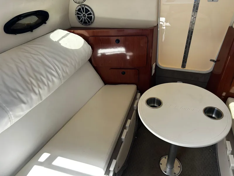 Slide: The Image of 2008 Ebbtide 2700 SS Bow Rider cabin interior with seating and table. - 12