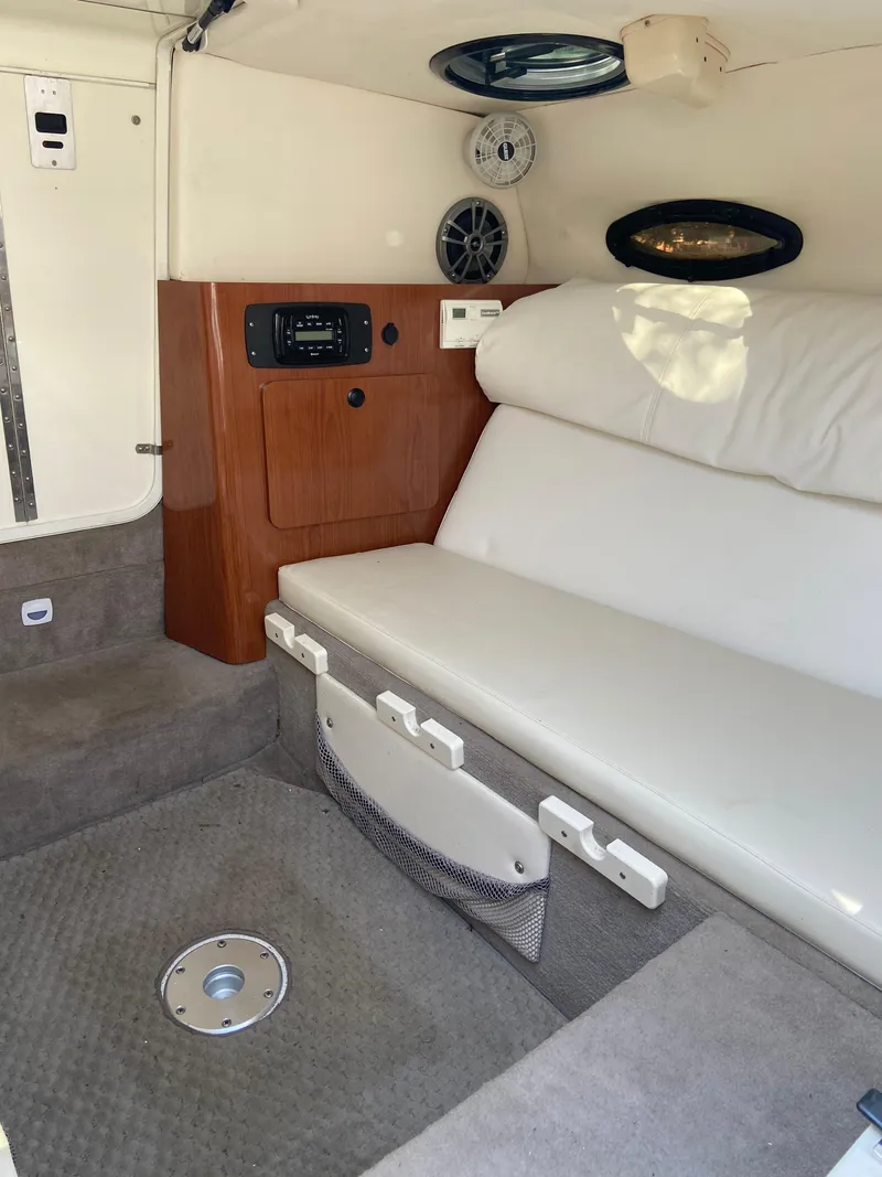 Slide: The Image of Interior of 2008 Ebbtide 2700 SS Bow Rider/CD with white seating and wood paneling. - 13