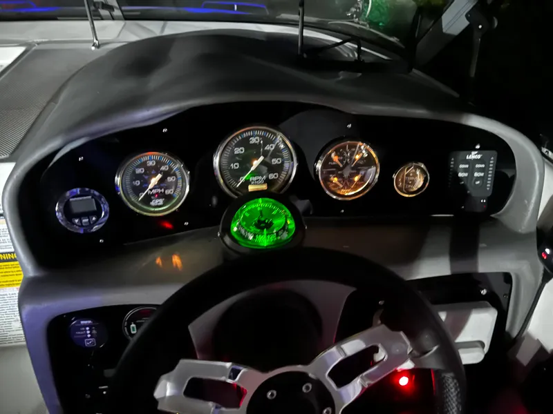 Slide: The Image of Dashboard of a 2008 Ebbtide 2700 SS Bow Rider/CD boat with illuminated gauges. - 5