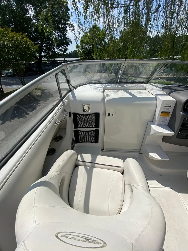 Slide: The Image of 2008 Ebbtide 2700 SS Bow Rider interior with white seating and dashboard view. - 6