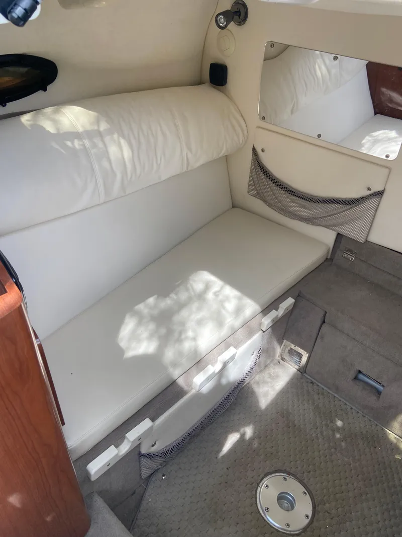 Slide: The Image of Interior of 2008 Ebbtide 2700 SS Bow Rider/CD with white seating and storage. - 9