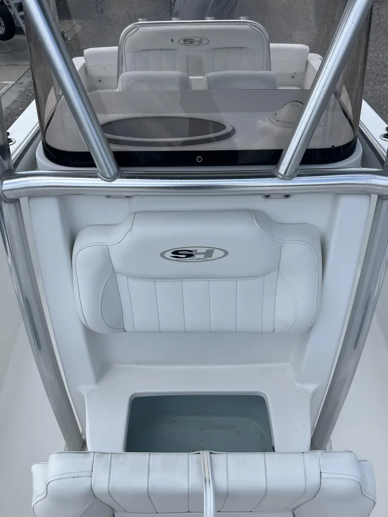 Slide: The Image of 2018 Sea Hunt Triton 210 boat interior with white seating and console. - 10