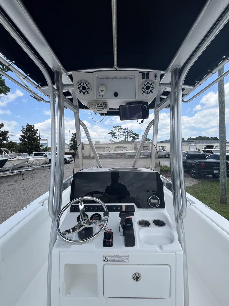 Slide: The Image of 2018 Sea Hunt Triton 210 boat console with steering wheel and controls. - 12