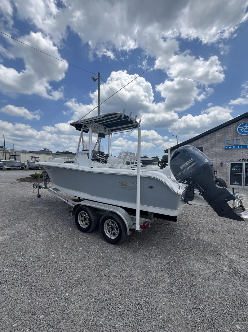 Slide: The Image of 2018 Sea Hunt Triton 210 boat on trailer under cloudy sky. - 2