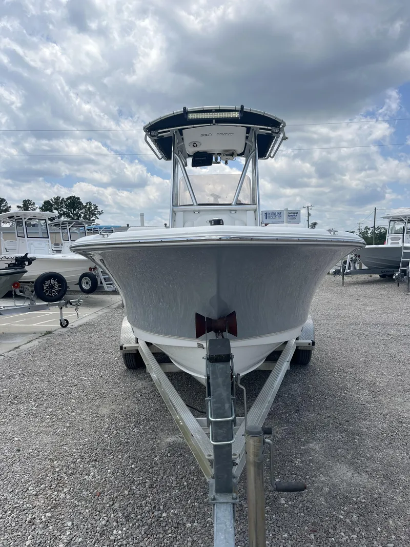 Slide: The Image of 2018 Sea Hunt Triton 210 boat on trailer under cloudy sky. - 5