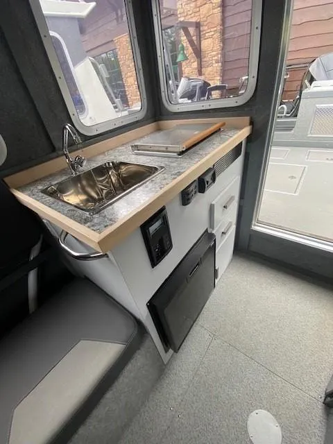 Slide: The Image of 2024 Spartan 2800 Olympia interior with compact kitchenette and modern design. - 2