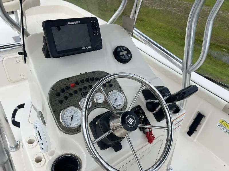 Slide: The Image of 2023 Carolina Skiff 21 LS boat console with steering wheel and navigation system. - 13
