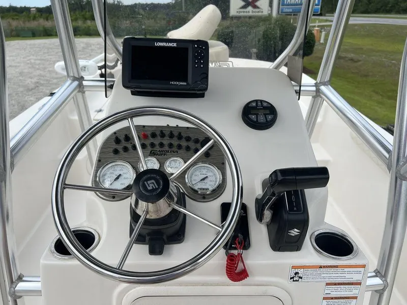 Slide: The Image of 2023 Carolina Skiff 21 LS boat console with steering wheel and navigation system. - 14