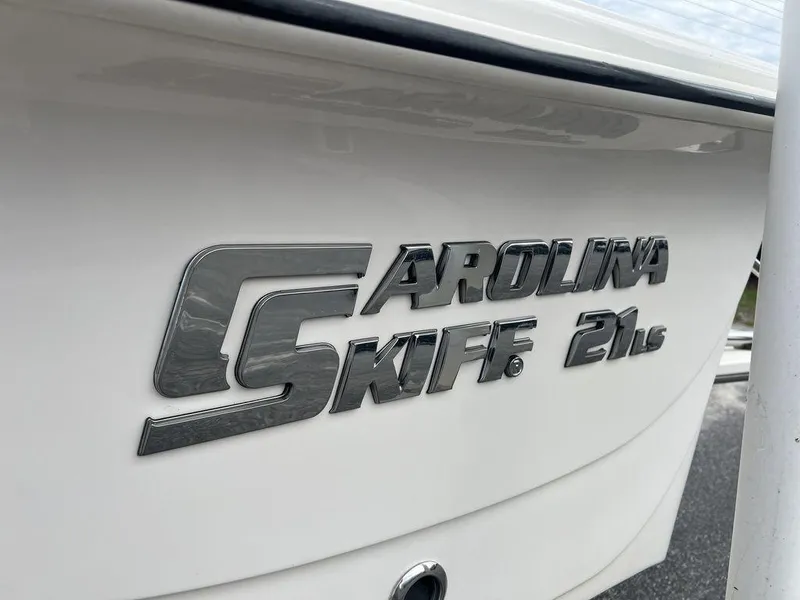 Slide: The Image of 2023 Carolina Skiff 21 LS boat logo on white hull. - 17