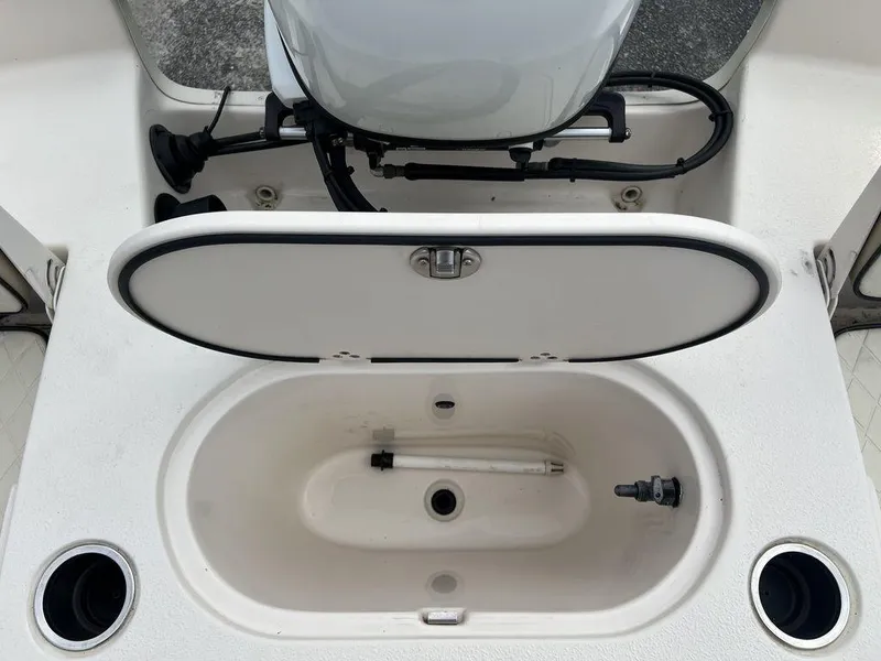 Slide: The Image of 2023 Carolina Skiff 21 LS boat livewell with open lid and cup holders. - 18