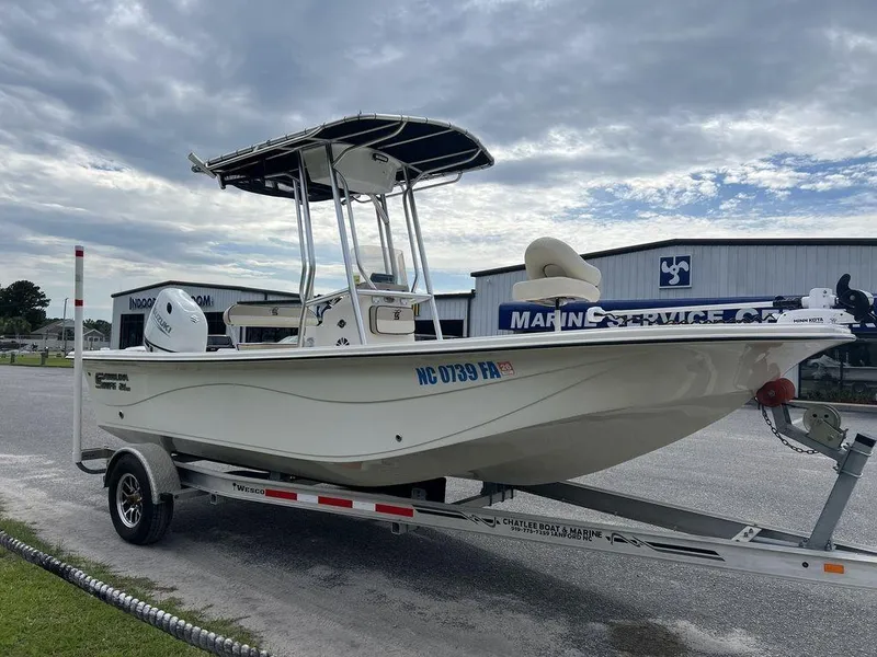 Slide: The Image of 2023 Carolina Skiff 21 LS boat on trailer, parked outdoors near marine service center. - 5