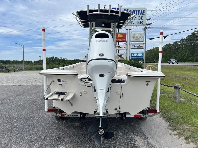 Slide: The Image of 2023 Carolina Skiff 21 LS boat with outboard motor at a marine service center. - 8