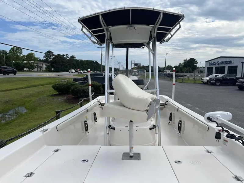 Slide: The Image of 2023 Carolina Skiff 21 LS boat with center console and seating, parked outdoors. - 9