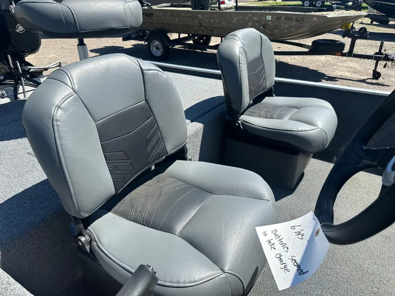 Slide: The Image of 2019 Tracker Classic boat seats with gray upholstery and a note attached. - 10