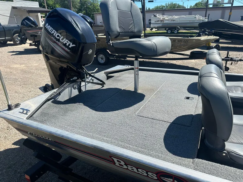 Slide: The Image of 2019 Tracker Classic boat with Mercury engine and seating, parked outdoors. - 12