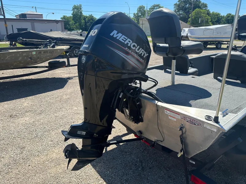 Slide: The Image of 2019 Tracker Classic boat with Mercury outboard motor in a sunny outdoor setting. - 14