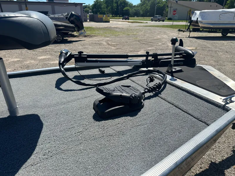 Slide: The Image of 2019 Tracker Classic boat deck with trolling motor and foot pedal in a sunny outdoor setting. - 7