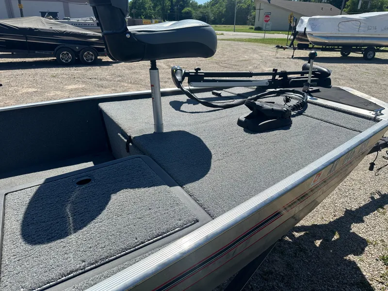 Slide: The Image of 2019 Tracker Classic boat with seating and equipment on deck, parked outdoors. - 8
