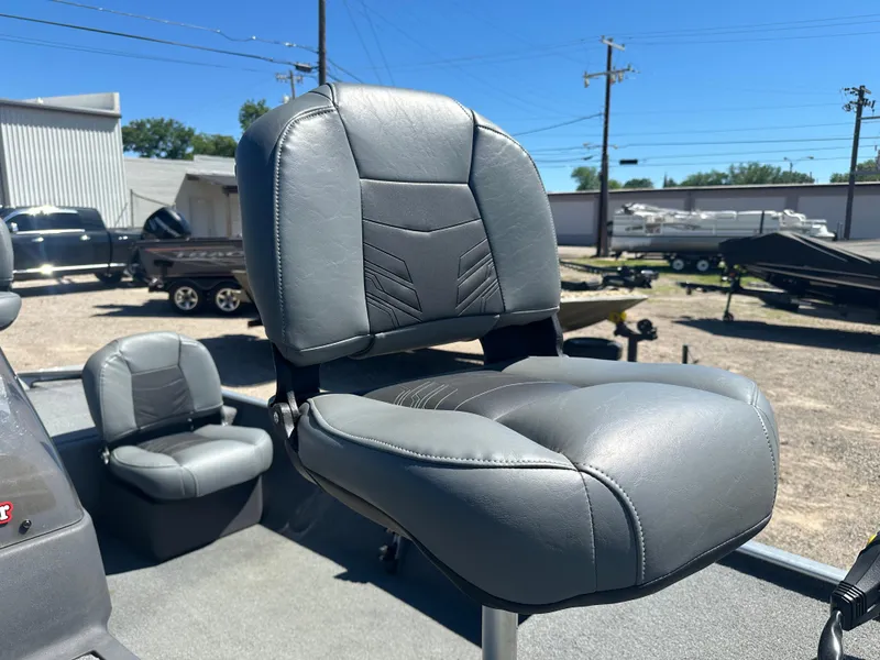 Slide: The Image of 2019 Tracker Classic boat seat, gray leather, outdoor setting, sunny day. - 9