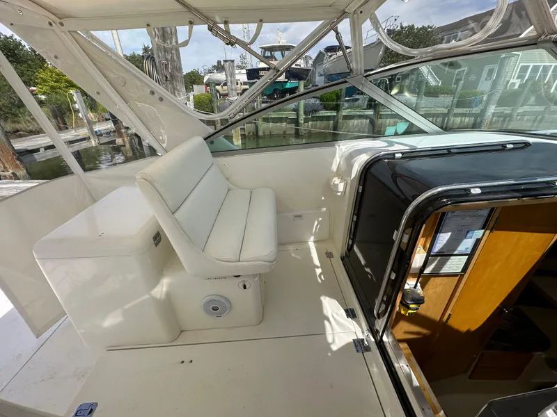 Slide: The Image of 1994 Bertram 30 Express Fisherman boat interior with white seating and cabin entrance. - 11
