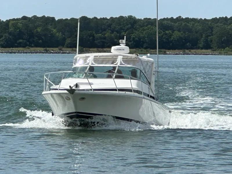 Slide: The Image of 1994 Bertram 30 Express Fisherman boat cruising on a calm lake. - 16