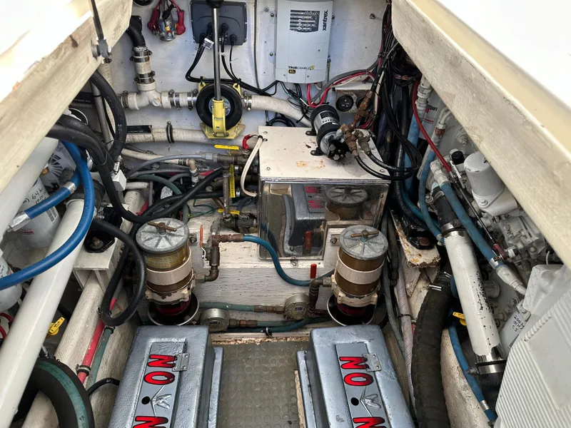 Slide: The Image of Engine room of a 1994 Bertram 30 Express Fisherman boat, showcasing mechanical components. - 23