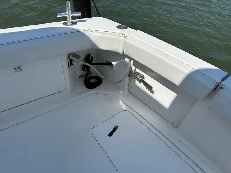 Slide: The Image of 1994 Bertram 30 Express Fisherman boat deck with seating and fishing rod holder. - 25