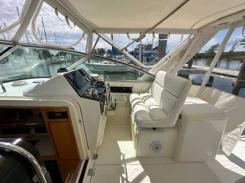 Slide: The Image of 1994 Bertram 30 Express Fisherman boat interior with helm and seating area. - 3