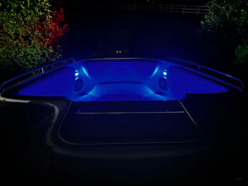Slide: The Image of 2008 Ebbtide 2700 Cuddy Bow Rider with blue interior lighting at night. - 17