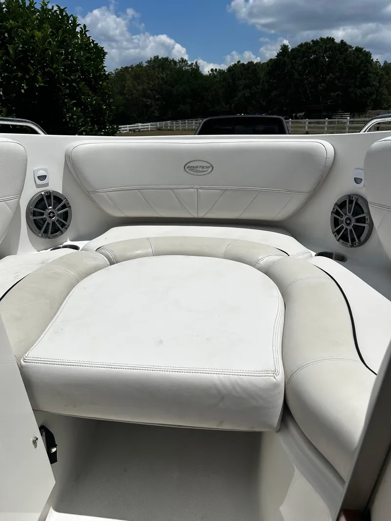 Slide: The Image of 2008 Ebbtide 2700 Cuddy Bow Rider interior with white seating and speakers. - 19